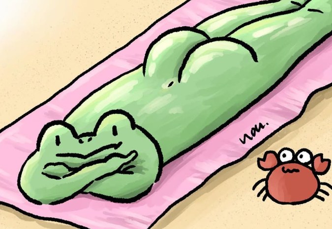 Fung lying face down on a pink towel at the beach, a crab nearby