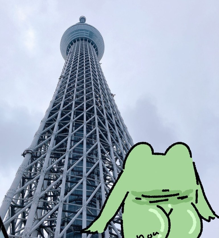 Fung peeking into frame in front of Tokyo Skytree